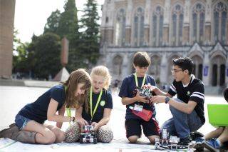 Students and teachers building robots outside