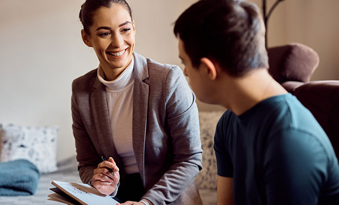 Professional woman working with young autistic person