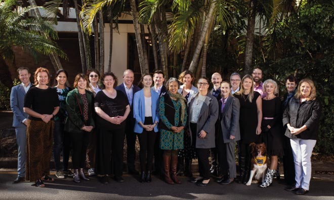 Photograph of Autism CRC staff in front of the leafy office at Long Pocket Precinct, UQ