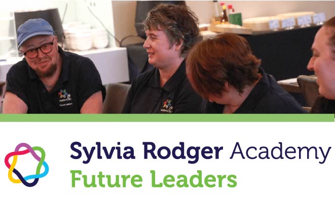 Photograph of people in a conference room smiling. Text" Sylvia Rodger Academy - Future Leaders