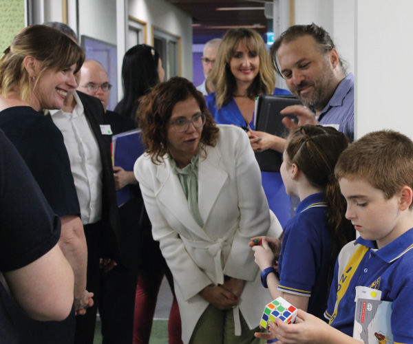 Amanda Rishworth talking to some children in a crowd of people.