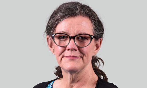 Photograph of Kathy Isaacs, showing head and shoulders, wearing professional atire.